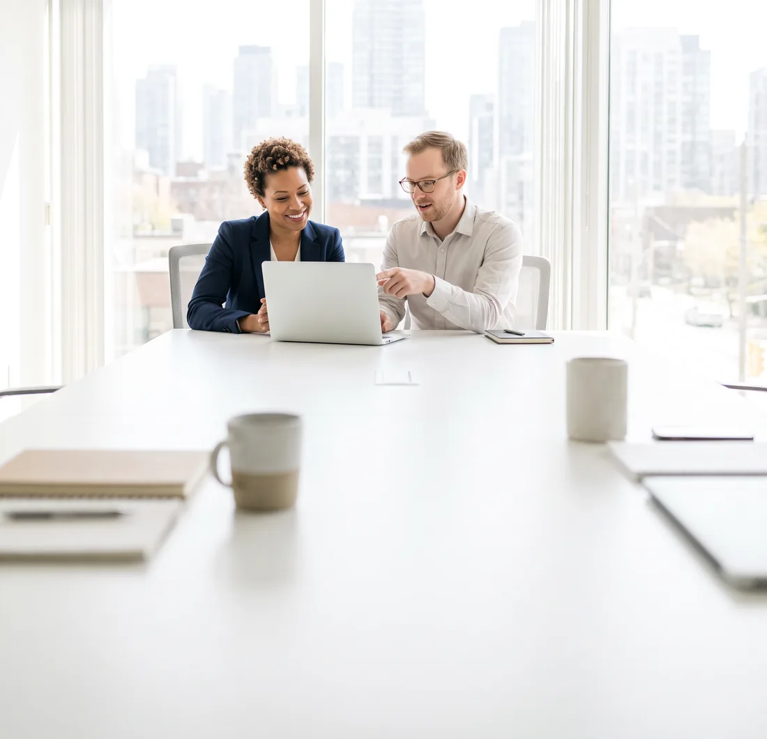 Business owner and consultant reviewing reputation scorecard results at a laptop