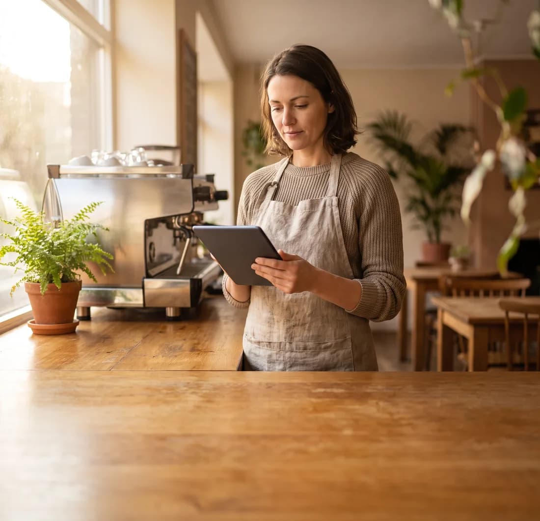 Cafe owner reviewing prioritized local SEO recommendations on a tablet