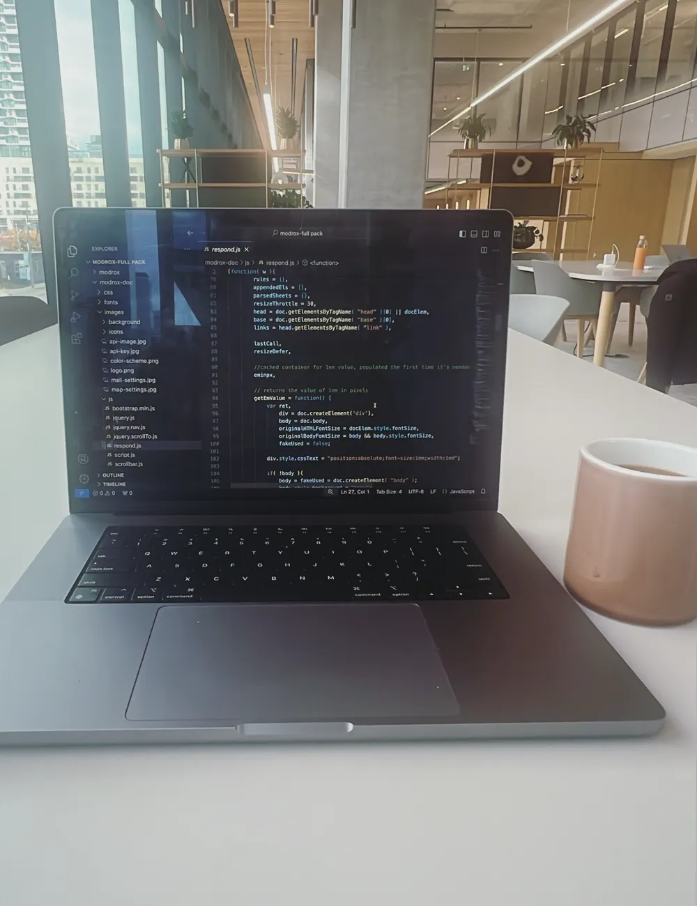Custom code in progress on a laptop at the Cloud3 workspace